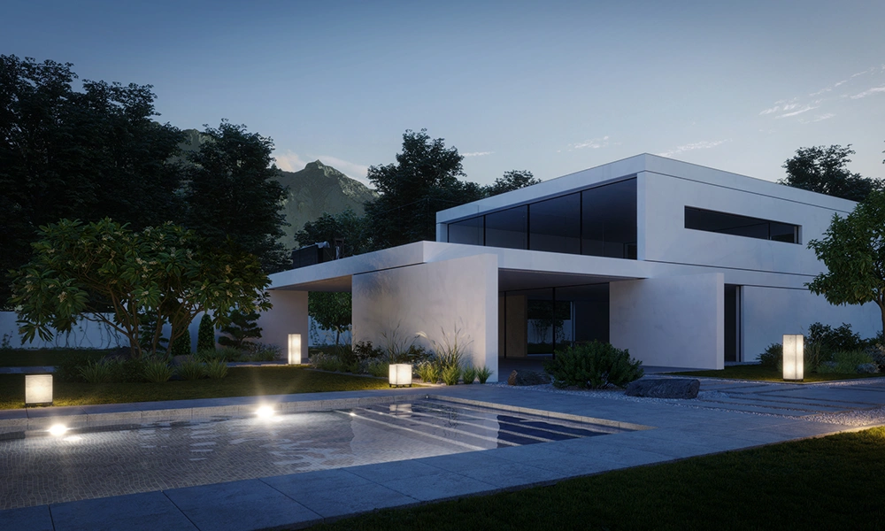 Evening view of a modern cubic architecture home with illuminated path lights and a mountain backdrop.