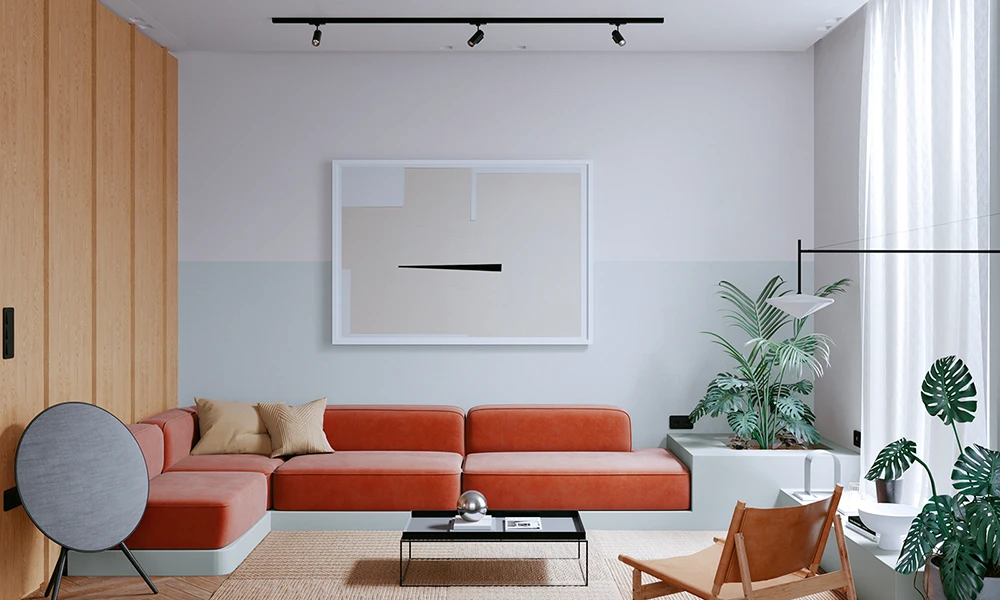 Ein modernes Wohnzimmer im Mid Century Interior Stil mit einem rostfarbenen Ecksofa, einem minimalistischen Couchtisch und einer abstrakten Kunstgrafik an der Wand. 