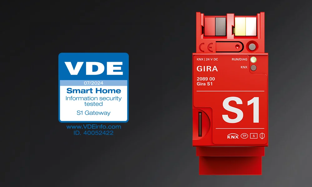 A red Gira S1 smart home gateway device with VDE information security certification label.