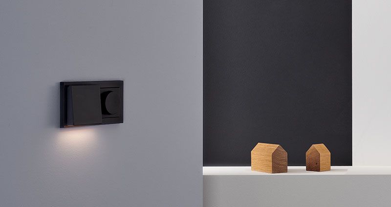 Power supply and lighting source in one device: Plug & Light featured by Gira proves particularly convenient in bedrooms.